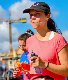 Girl eating an orange girl while running